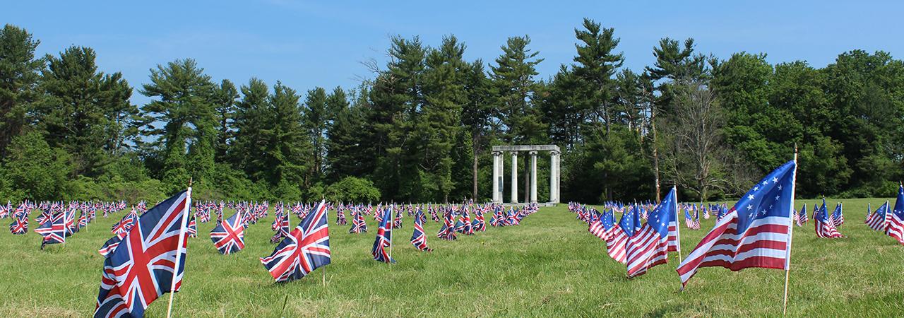 American and British flags waving on the grounds of the Princeton Battlefield