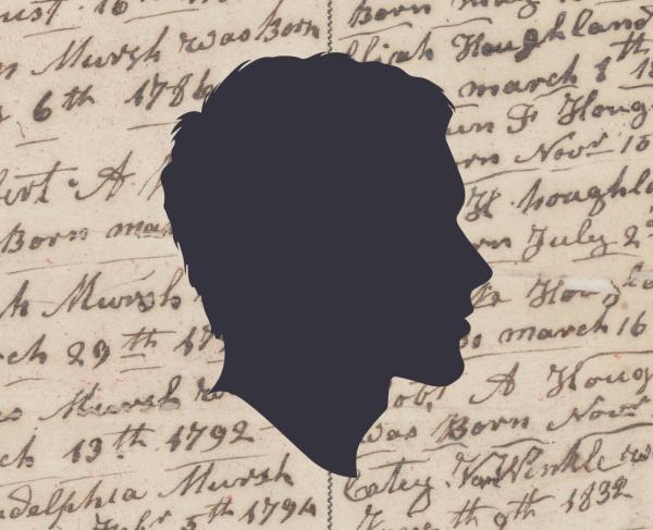 Silhouette of a man in front of written document.